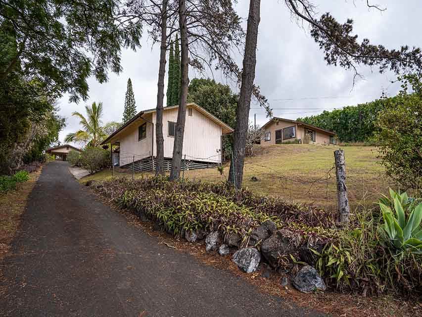 507 Lower Kimo Drive Kula, HI 96790 - Photo 1 of 30 a front view of a house with a yard and fountain in middle