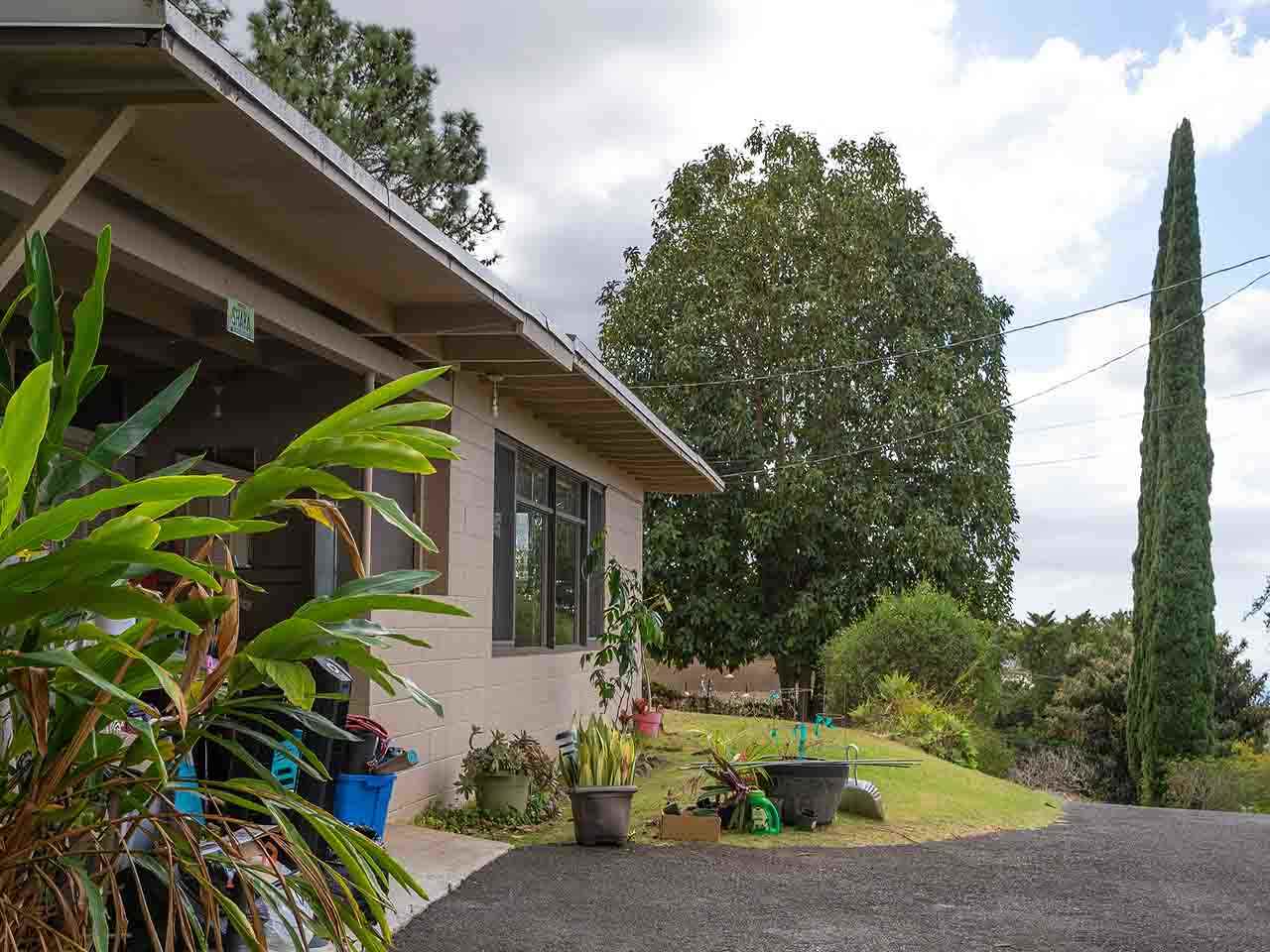 507 Lower Kimo Drive Kula, HI 96790 - Photo 11 of 30 a backyard of a house with table and chairs plants