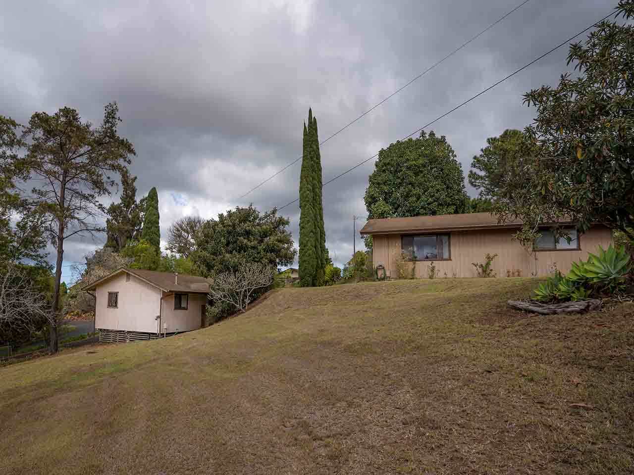 507 Lower Kimo Drive Kula, HI 96790 - Photo 6 of 30 a front view of a house with a yard and garage