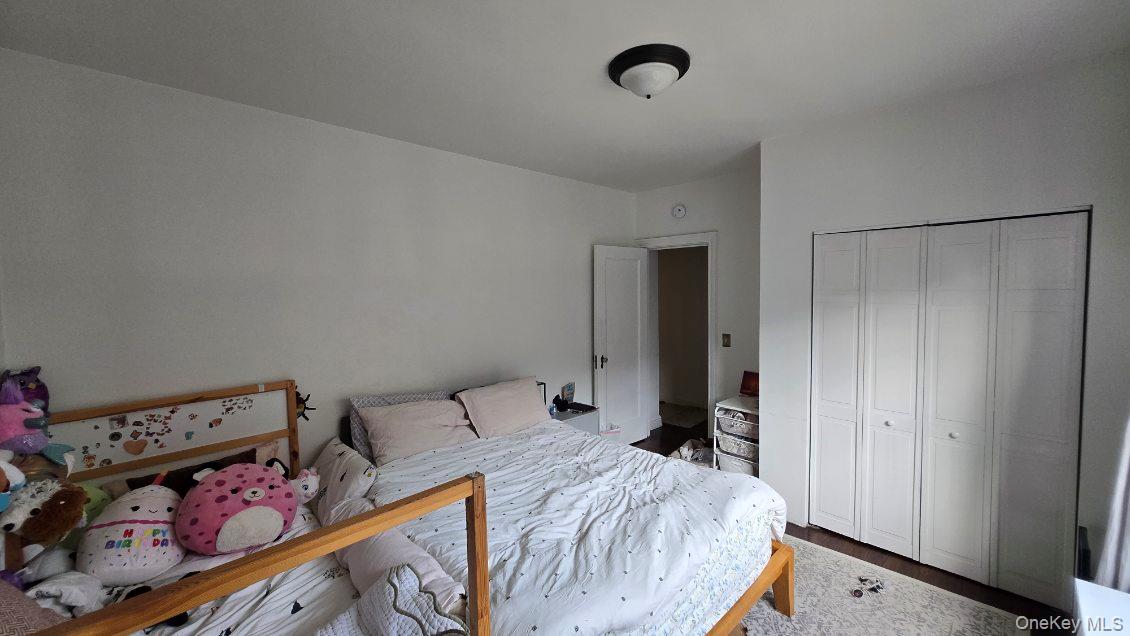 143 Garth Road, Unit 1J Scarsdale, NY 10583 - Photo 14 of 24 a bed room with a bed