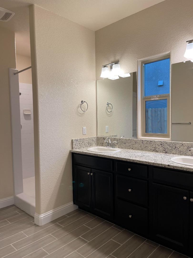 2411 Gabriel Drive Merced, CA 95340 - Photo 13 of 22 a bathroom with a sink and a mirror