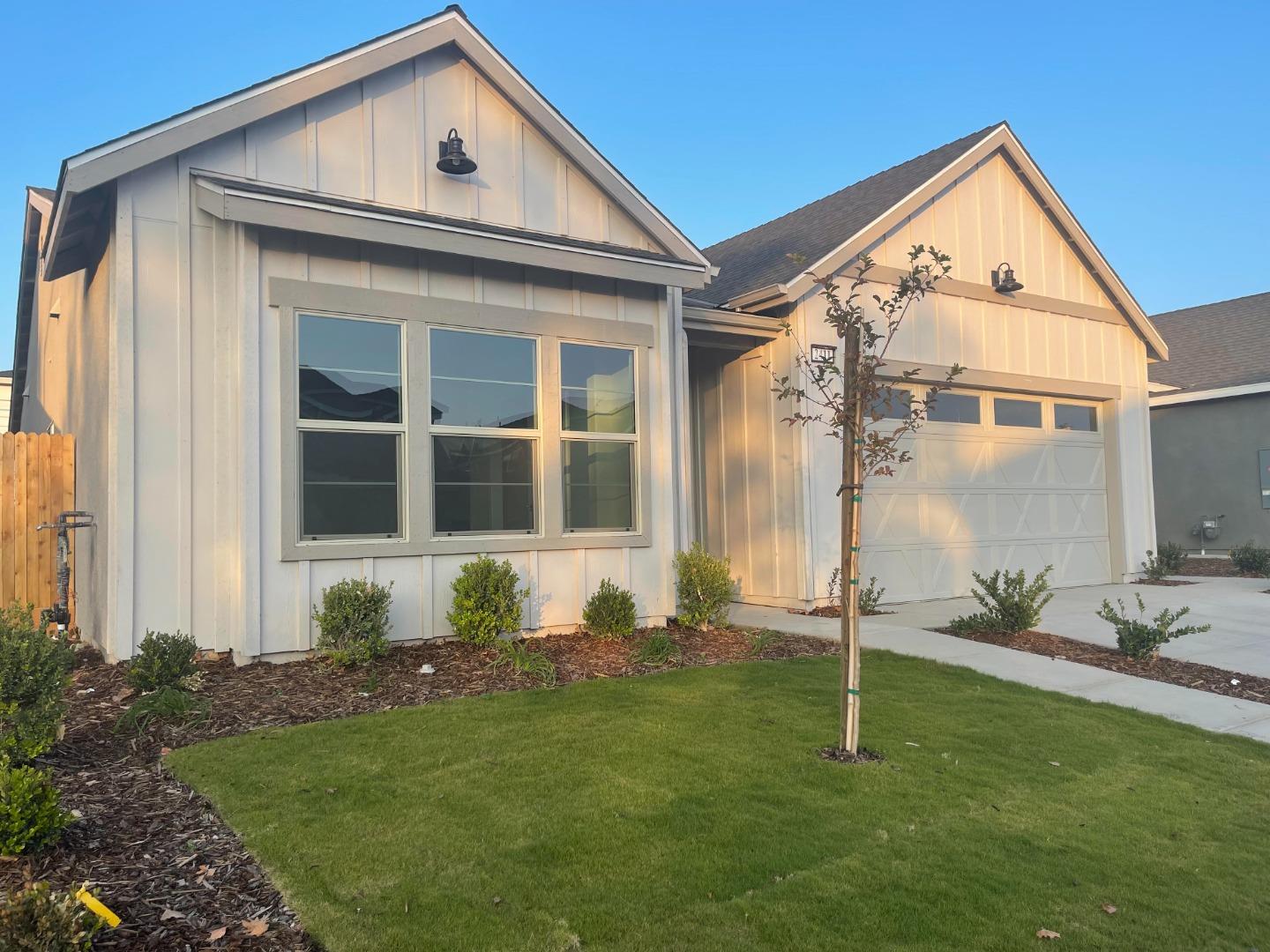 2411 Gabriel Drive Merced, CA 95340 - Photo 2 of 22 a front view of a house with a garden and plants