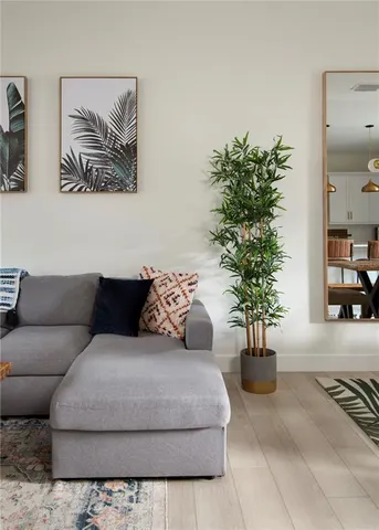 a living room with furniture and a potted plant