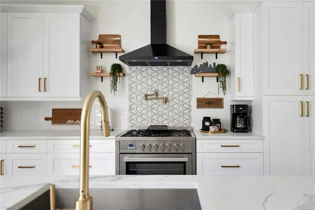 a kitchen with stainless steel appliances a stove a sink and a refrigerator