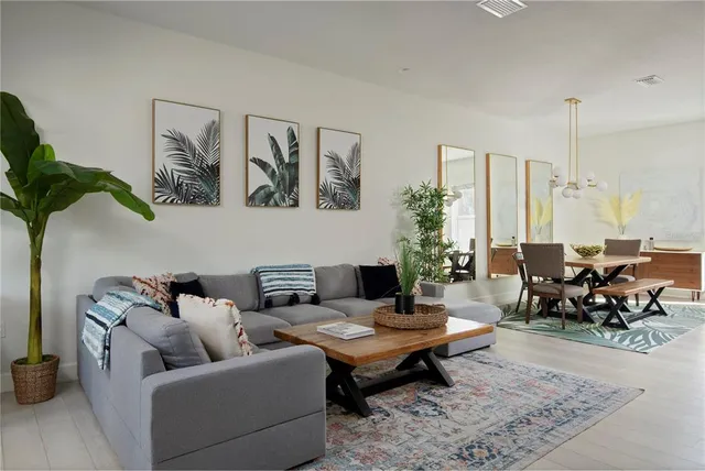 a living room with furniture flowerpot and a potted plant