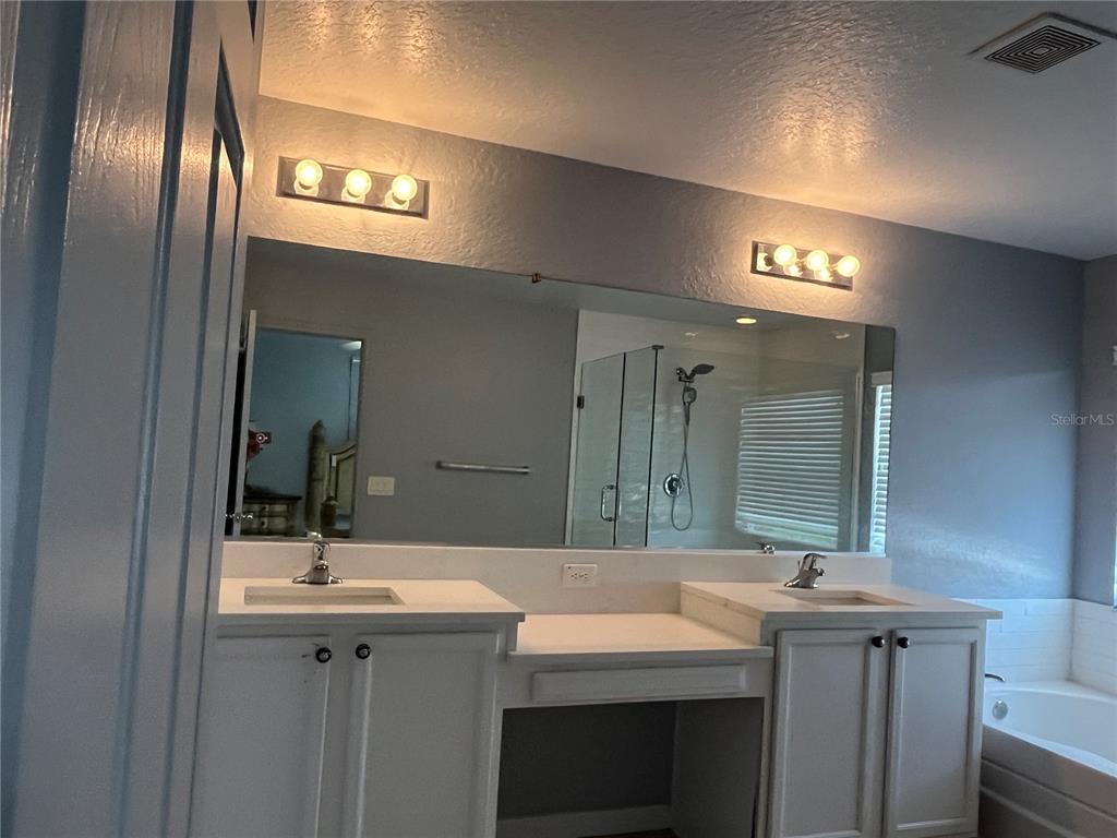 4943 Southwest 41st Place Ocala, FL 34474 - Photo 21 of 30 a bathroom with a sink and a mirror