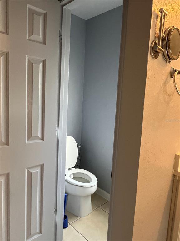 4943 Southwest 41st Place Ocala, FL 34474 - Photo 22 of 30 a white toilet sitting next to a bathroom sink
