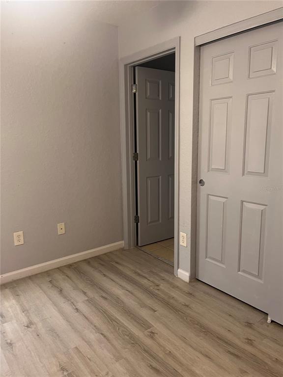 4943 Southwest 41st Place Ocala, FL 34474 - Photo 25 of 30 a view of an empty room with wooden floor and closet