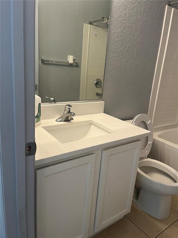 4943 Southwest 41st Place Ocala, FL 34474 - Photo 29 of 30 a bathroom with a sink toilet and mirror