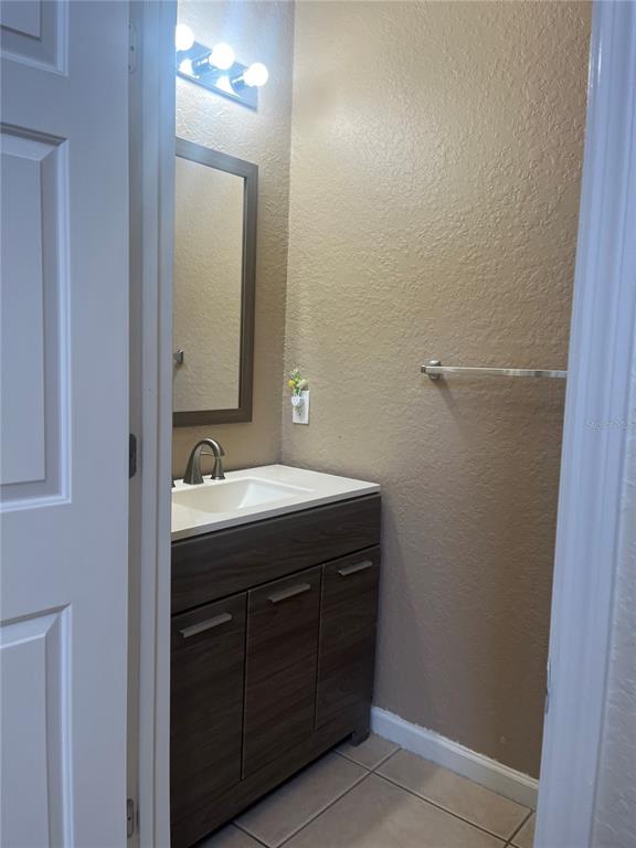 4943 Southwest 41st Place Ocala, FL 34474 - Photo 30 of 30 a bathroom with a sink and a mirror