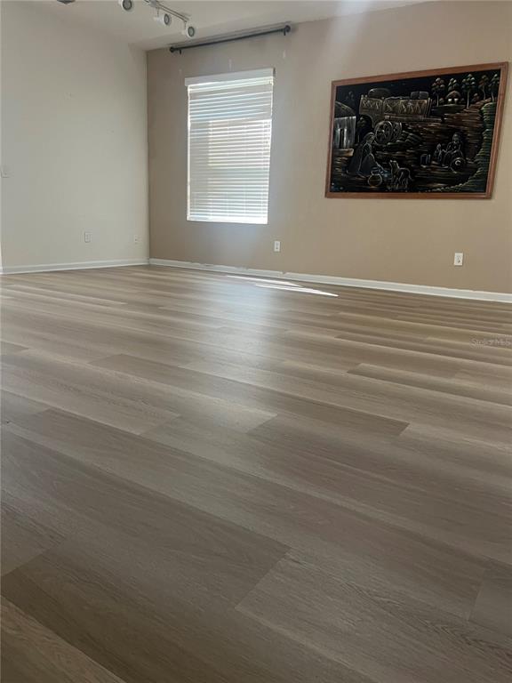 4943 Southwest 41st Place Ocala, FL 34474 - Photo 3 of 30 a view of a livingroom with an empty space stove wooden floor and window
