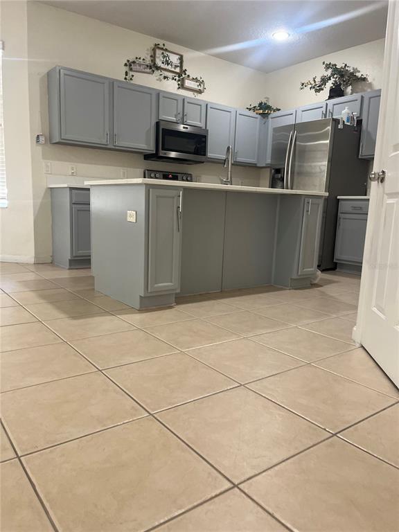 4943 Southwest 41st Place Ocala, FL 34474 - Photo 9 of 30 a kitchen with stainless steel appliances granite countertop a refrigerator and a sink