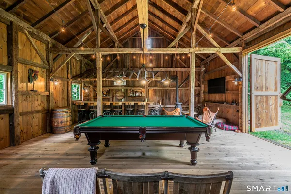a room with pool table and windows