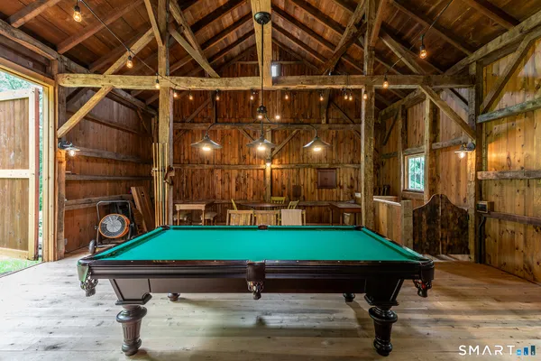 a room with pool table and windows