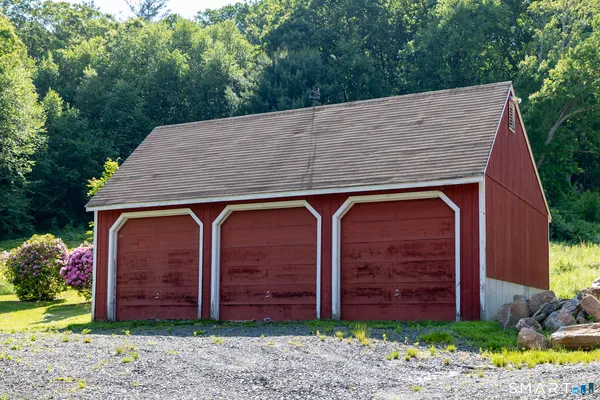 a view of a small house with wooden fence