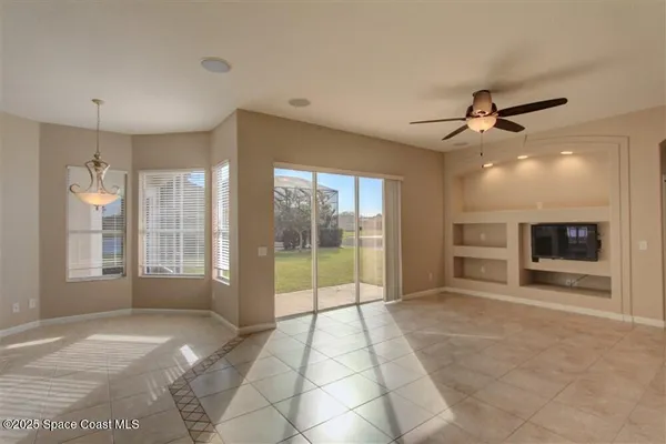 a view of an empty room with a fireplace and a large window