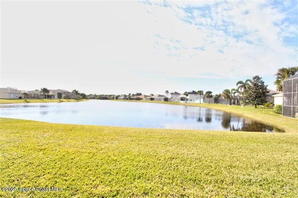 a view of a lake with houses in the back