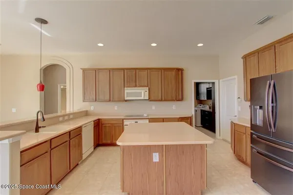 a kitchen that has a sink stainless steel appliances a counter space and cabinets
