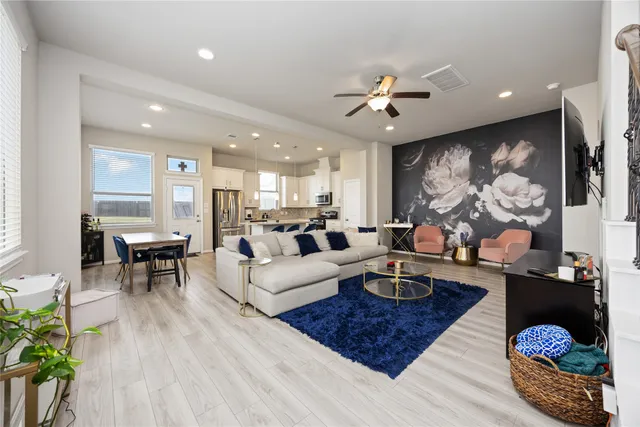 a living room with fireplace furniture and wooden floor