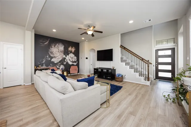 a living room with furniture a fireplace and a flat screen tv