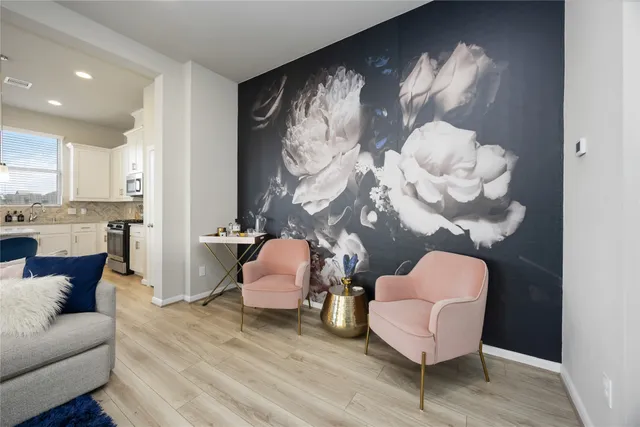 a living room with furniture and wooden floor