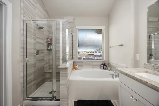 a bathroom with a shower sink and mirror