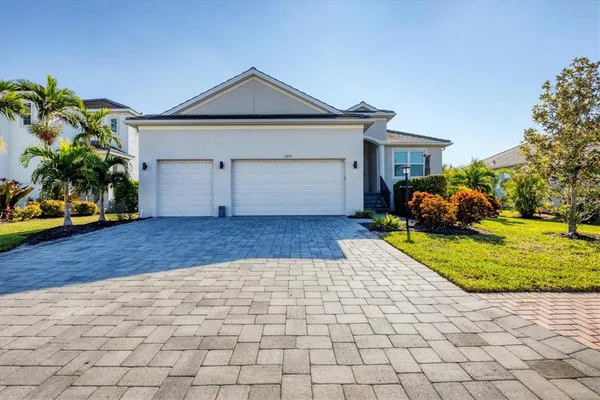 a front view of a house with a yard and garage