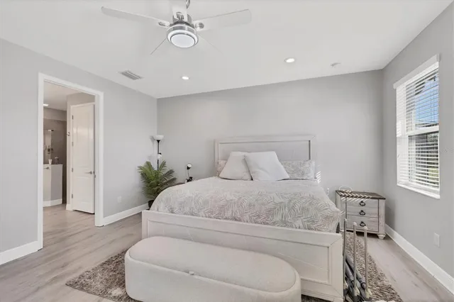 a spacious bedroom with a bed and a window