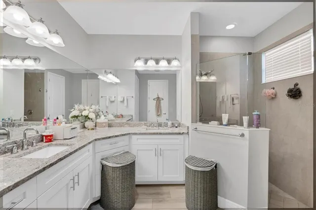 a kitchen with stainless steel appliances granite countertop a sink stove refrigerator and cabinets