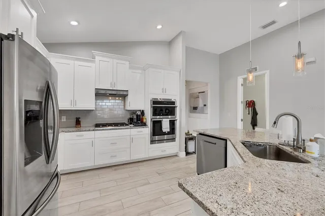 a large kitchen with a table and chairs in it