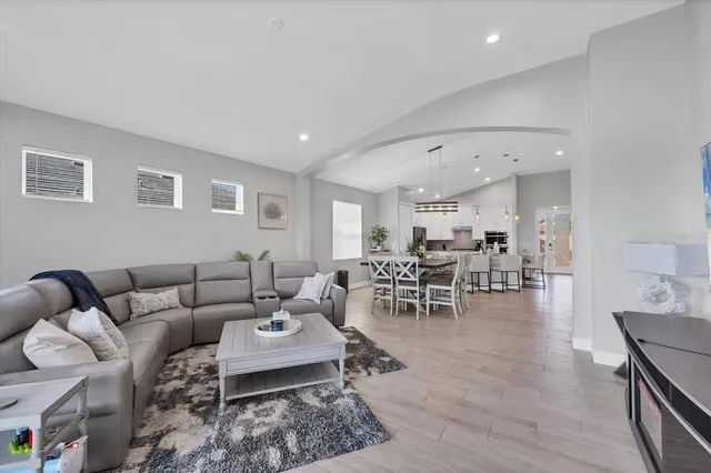 a view of a dining room with furniture a chandelier and wooden floor