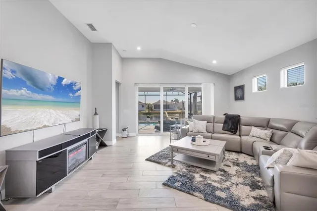 a kitchen with stainless steel appliances granite countertop a kitchen island hardwood floor and a sink