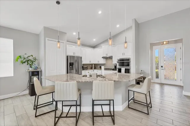 a bathroom with a granite countertop sink mirror vanity and toilet