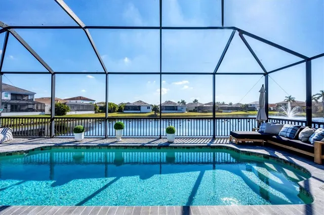 a view of a patio with table and chairs under an umbrella