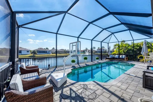 a view of a house with swimming pool and sitting area