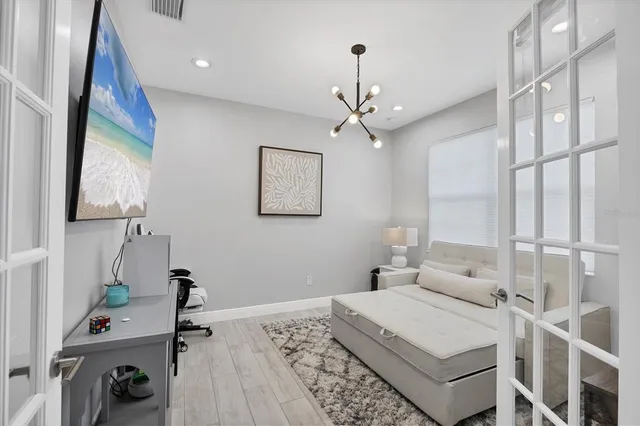 a bedroom with a bed dresser and a window