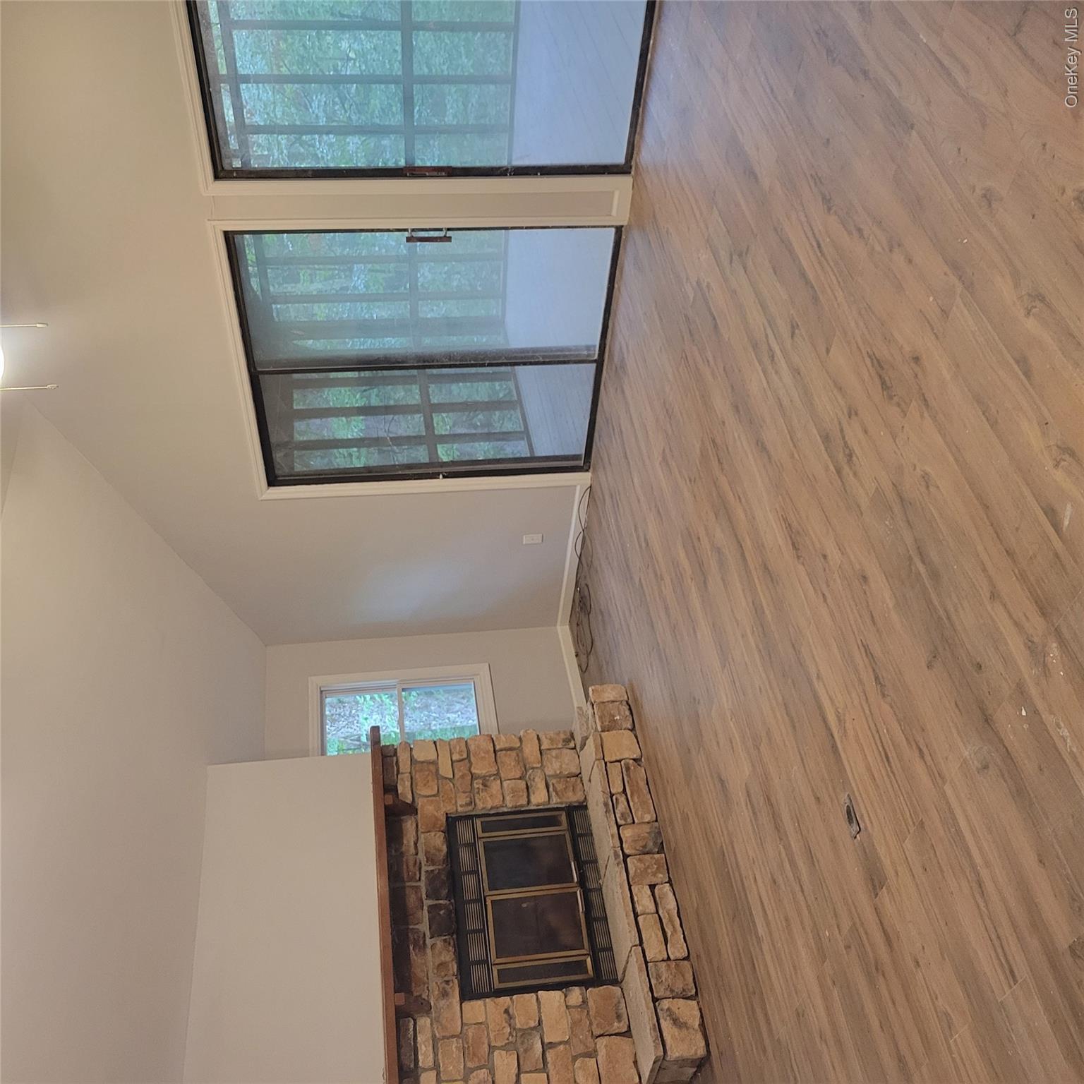 21 Browns Road Livingston Manor, NY 12758 - Photo 8 of 19 an empty room with wooden floor and fireplace