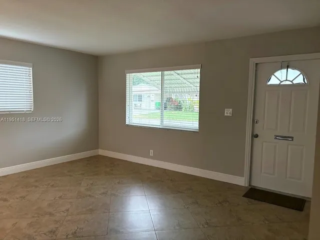 a view of an empty room with a window