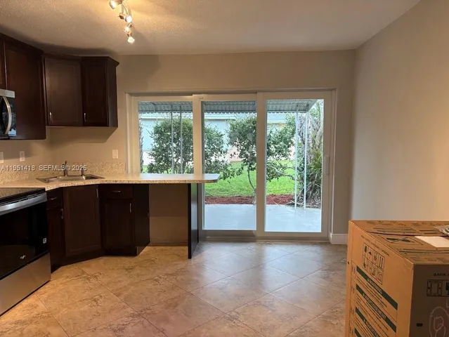 a kitchen with a large window and a sink