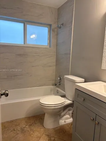 a bathroom with a toilet and a bath tub
