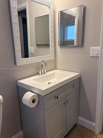 a bathroom with a sink and a mirror