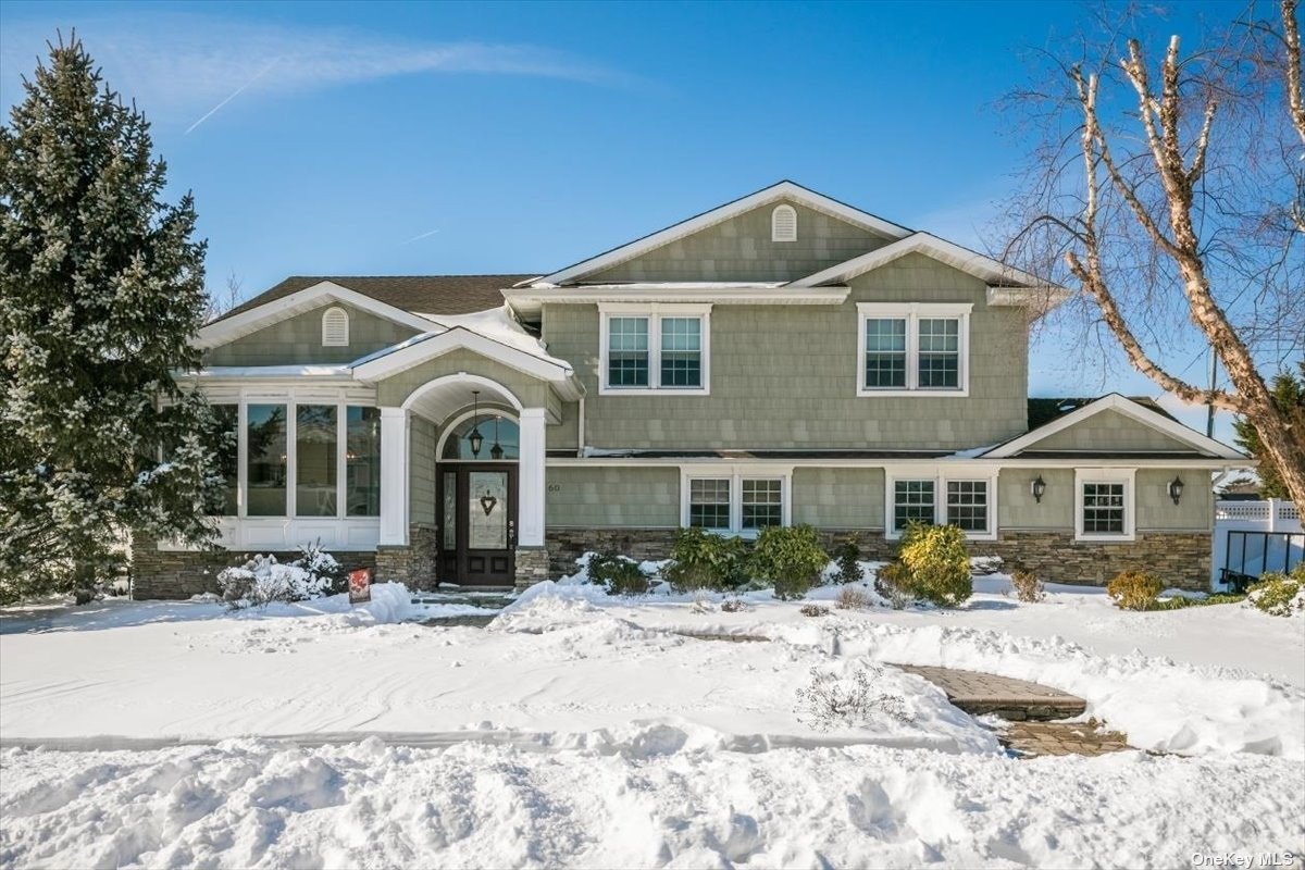 60 Rainbow Road Massapequa Park, NY 11762 - Photo 1 of 1 a front view of a house with a yard covered in snow