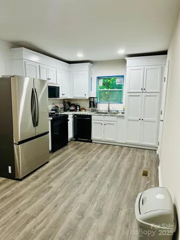 a kitchen with a refrigerator and a stove