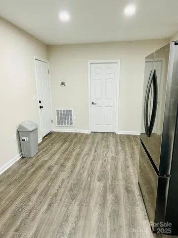 a view of a room with wooden floor and staircase