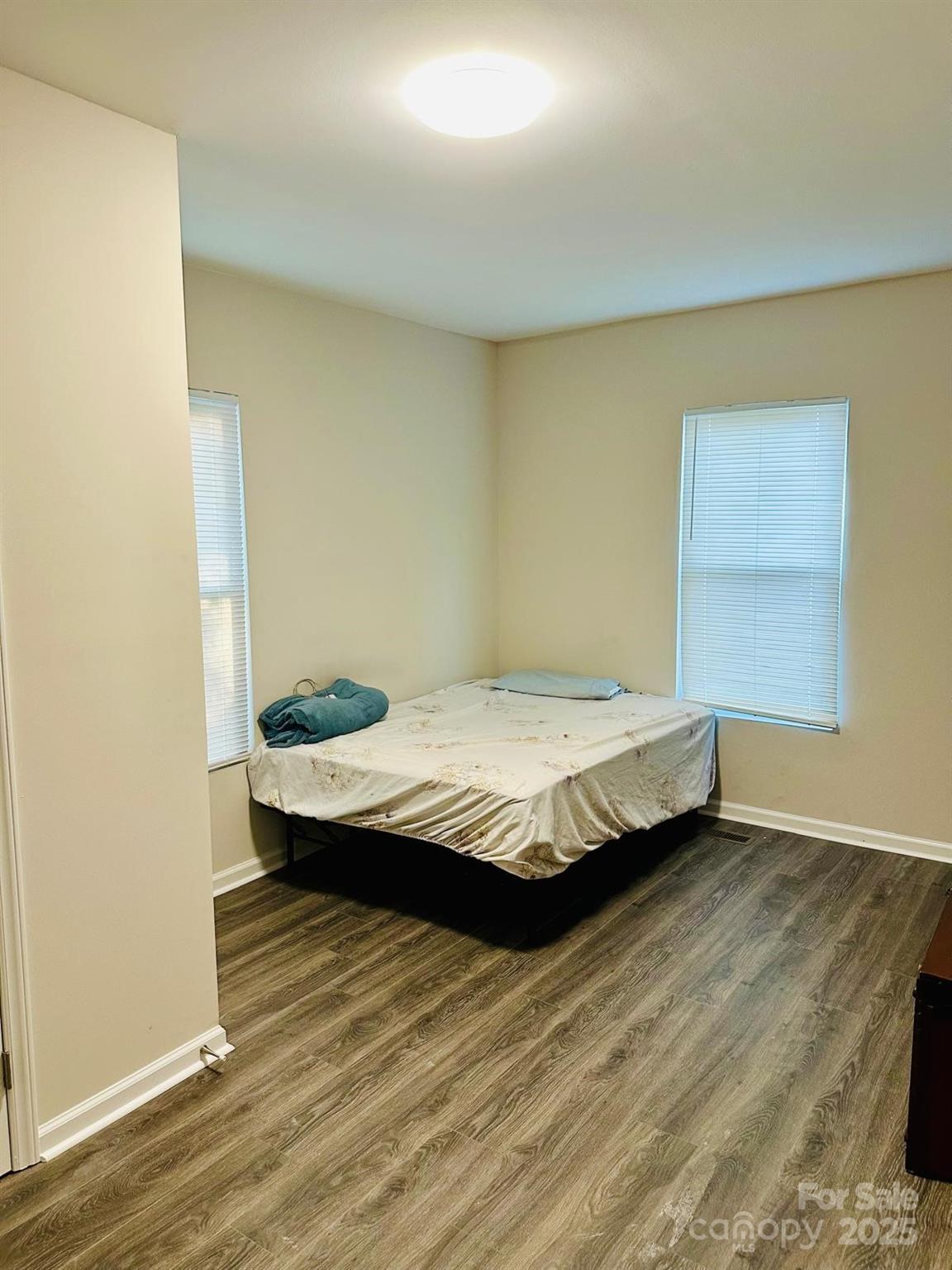 1010 13th Street, Unit 11 Lancaster, SC 29720 - Photo 15 of 22 a bedroom with a bed and wooden floor