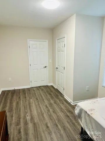 a view of an empty room and wooden floor