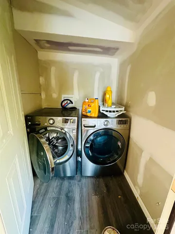 a kitchen with a stove and a wooden floor