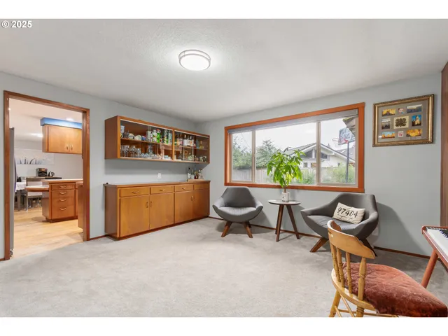 a living room with furniture a rug and a large window