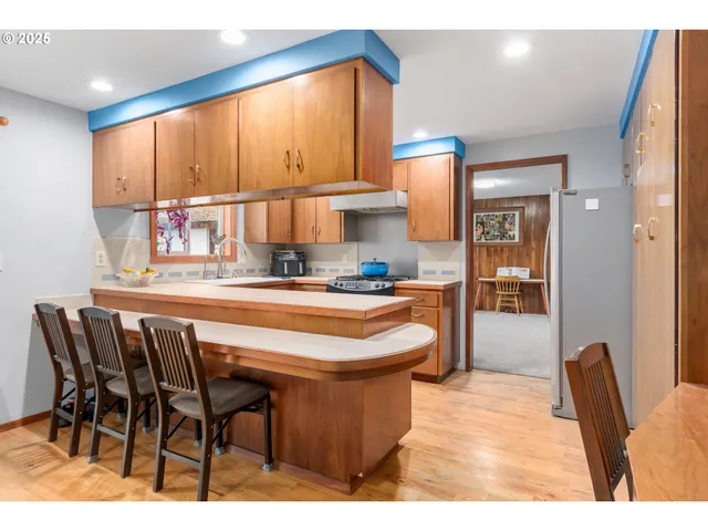 a kitchen with stainless steel appliances a sink stove and cabinets