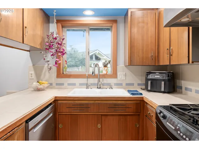 a kitchen with cabinets a sink and appliances